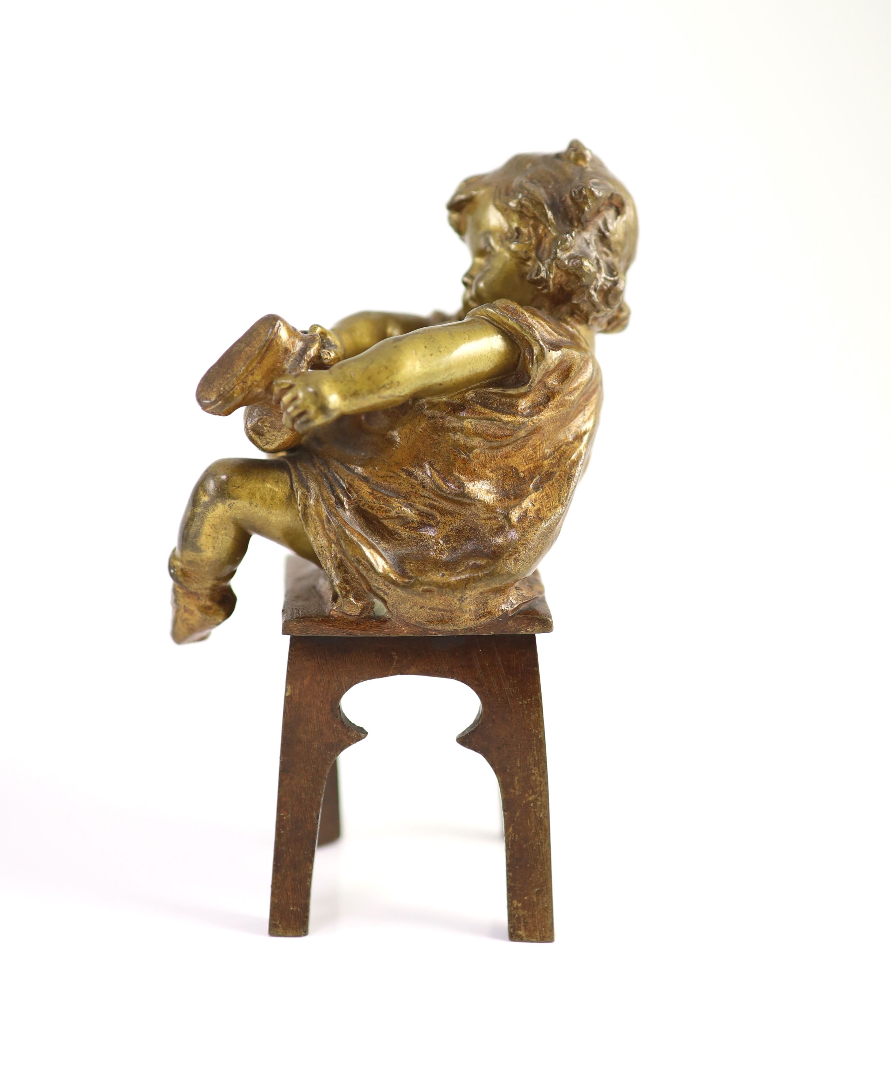 After Joan Clarà (1875 - 1958). A pair of bronze models of girls playing on chairs, height 15.5cm